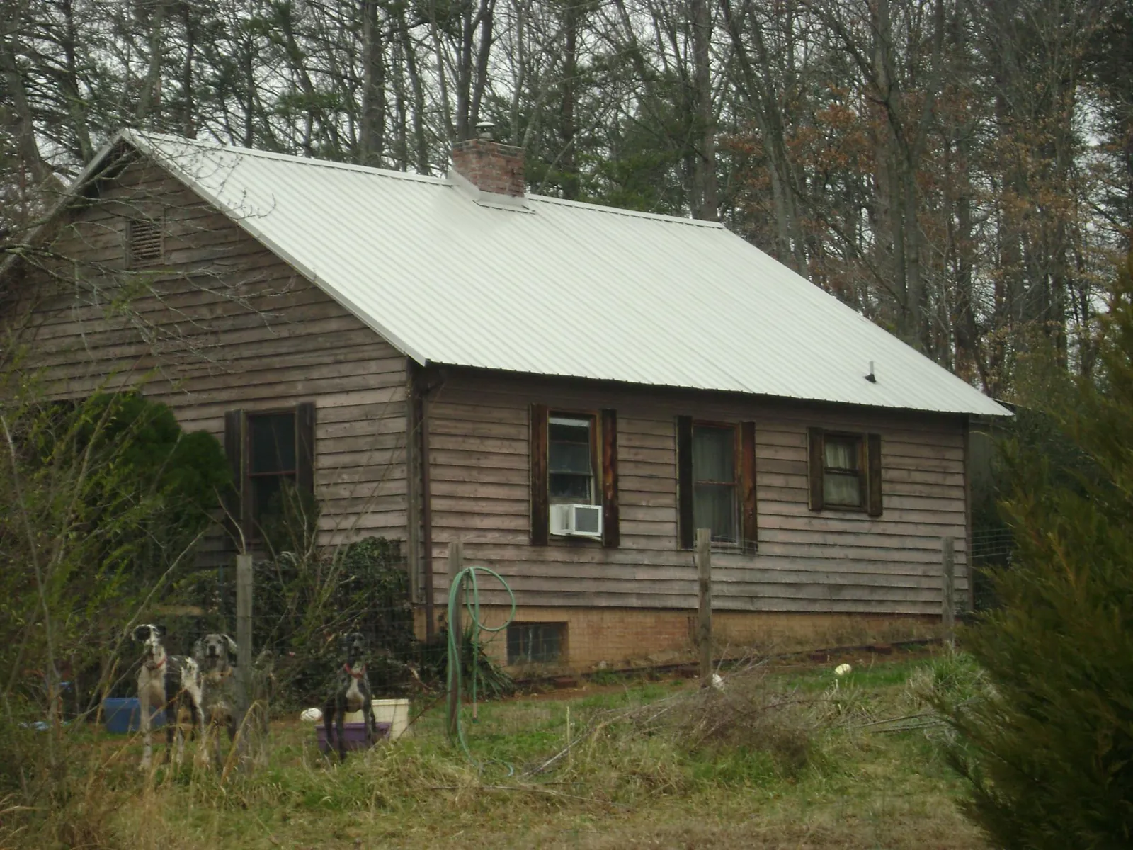 White metal roof on an old wood sided farmhouse, from a Metal Roof Installation job in Grainfield